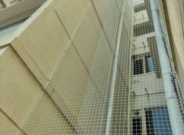 Apartment duct area wrapped neatly with pigeon netting.