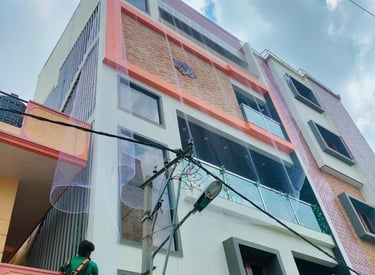 Wide shot showing a residential building with duct area nets preventing pigeons.