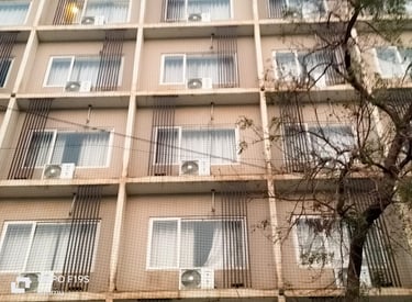 Balcony covered with a neatly installed pigeon net to prevent bird entry.