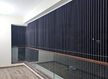 Close-up of a sleek, transparent invisible grill installed on a window in a modern home.