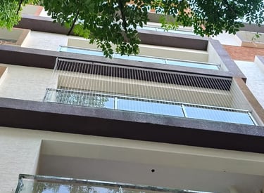 A wide shot showing a balcony with custom invisible grills in royapettah