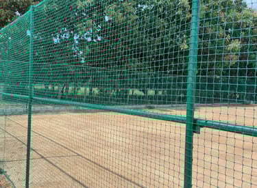 Volleyball net installed on a rooftop with cityscape background.