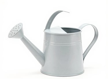 A sturdy garden hose coiled neatly beside a blooming flower bed on a sunny day.