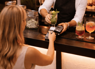 Guest making a card payment at a mobile cash bar operated by Shaken Events.