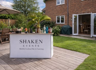 Branded Shaken Events mobile cocktail bar setup for a private garden event.