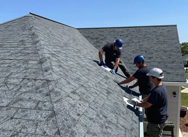 A professional roofer carefully inspecting a residential roof under clear skies.