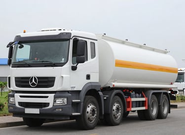 A modern fuel tanker truck transporting diesel on a highway at sunset.