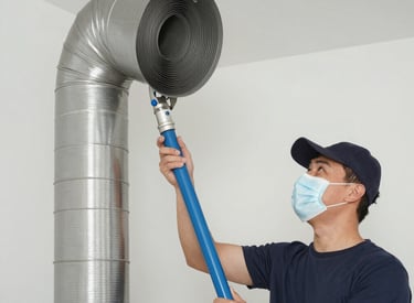 Technician cleaning vent ducts with professional equipment in a bright living room