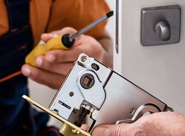 a man in a orange shirt is holding a screwdriver