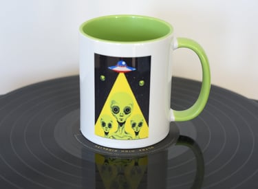 Aliens in beam from spaceship on mug 