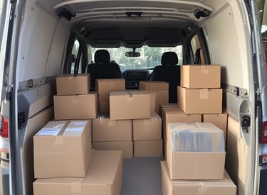A driver loading parcels into a delivery van ready for the day.