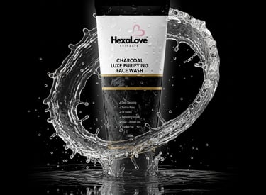 HexaLove Charcoal Luxe face wash tube with water splash on black background