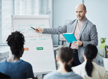 a man in a suit and tie is giving a presentation