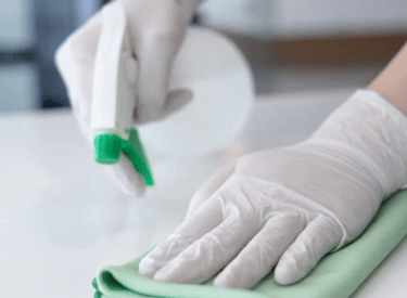 Cleaning a counter with cleaning solution in a spray bottle and a microfiber cloth
