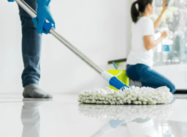 mopping a floor in an empty room and cleaning the window