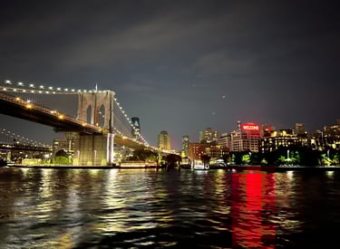 brooklyn bridge at night welcoming visitors into Brooklyn ny