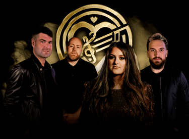 a group of people standing in front of a large golden emblem