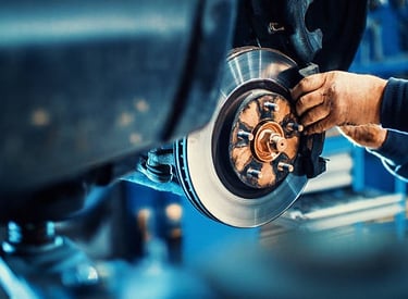 a man working on a car's brake disc