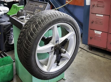 a tire on a wheel with a laptop on a stand