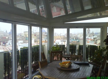 Veranda con Techo fijo y Plegables. Atico con vistas a la ciudad.