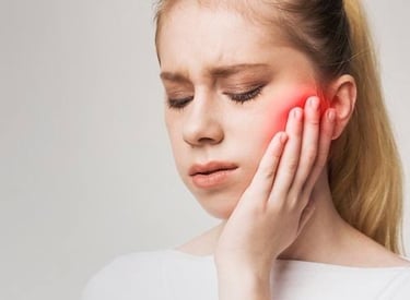 TMJ pain causing difficulty in chewing and jaw stiffness. 