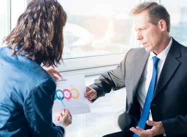 Web designer discussing a custom website solution with a client, showcasing EZ Web Builds' client-ce