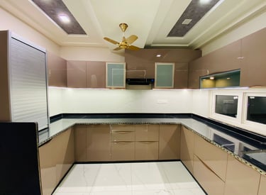 Modern modular kitchen design with wooden cabinets and marble countertop jaipur