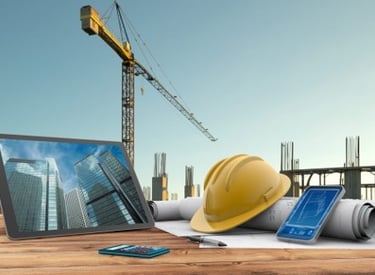 a tablet computer and a tablet with a construction helmet on top of it