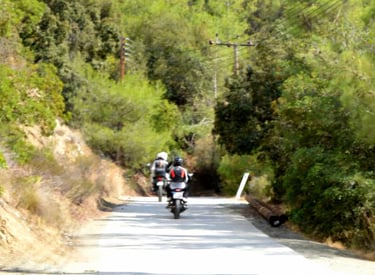 a person riding a motorcycle down a road, during our Cyprus photography tour