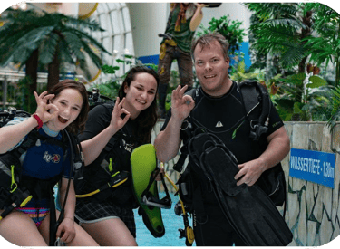 a group of people standing around a pool