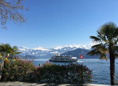 a boat on the water with mountains in the background