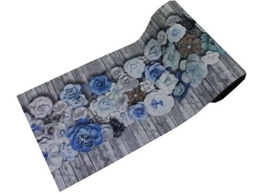 a roll of fabric with blue flowers on a wooden table