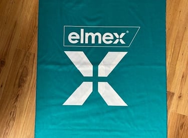 a towel on a wooden floor with a logo on it