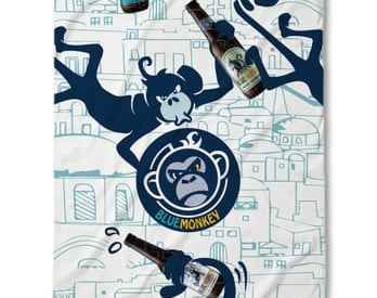 a towel with a monkey on it and a bottle of beer
