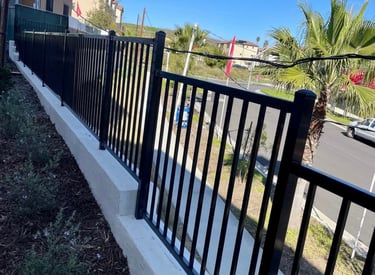Wrought iron fencing in top of block wall.