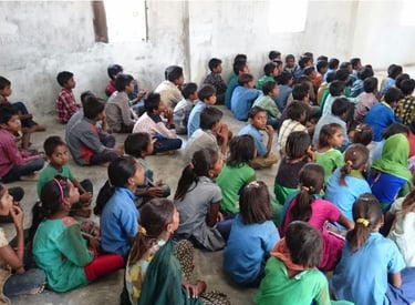 a group of children sitting on the ground