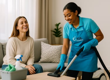 Kul Cleaning professional smiling while delivering eco-friendly cleaning services, leaving a satisfi