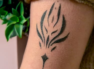 a tattoo style ornamentation tattoo on a woman's arm