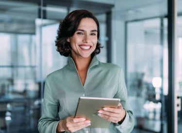 a smiling woman holding a tablet computer and smiling