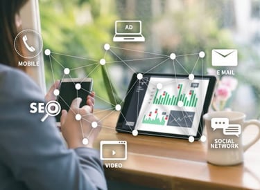 a woman sitting at a table with a tablet and a tablet