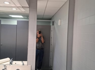 Bathroom mirror installation with sink and tiled walls