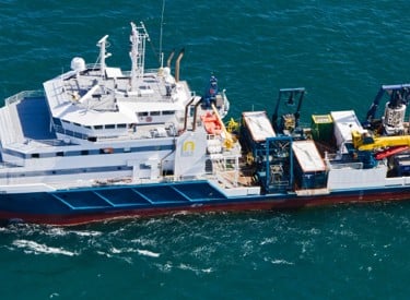 a boat with a large boat in the water