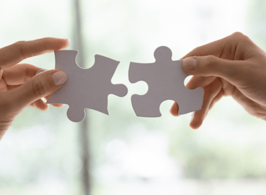 image of someone putting the pieces of a puzzle together