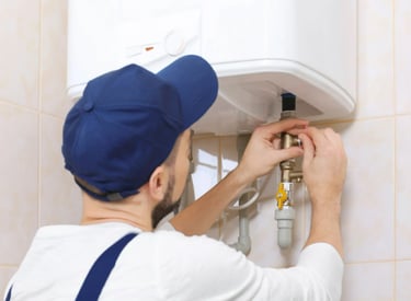 A plumber installing a water heater in a bathroom