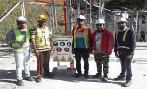 a group of men standing in front of a sign