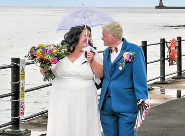 Happy Couple just married walking along the sea shore