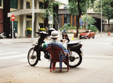 Motorbike driver resting on the street in Saigon
