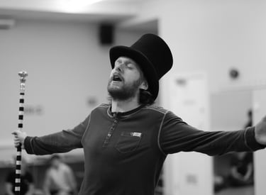 A man holding his arms out whilst singing