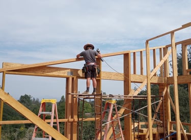 a man standing on a scaffold of wood beams