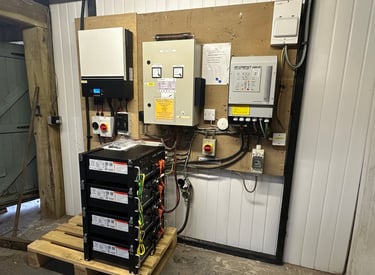 a room with a bunch of electrical equipment including a lithium battery pack off grid inverter
